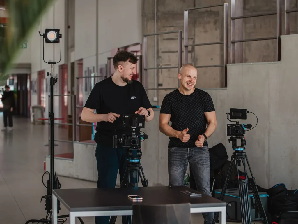 Vilius Žukauskas and Eugenijus Mačiukas laughing between takes on an interview set