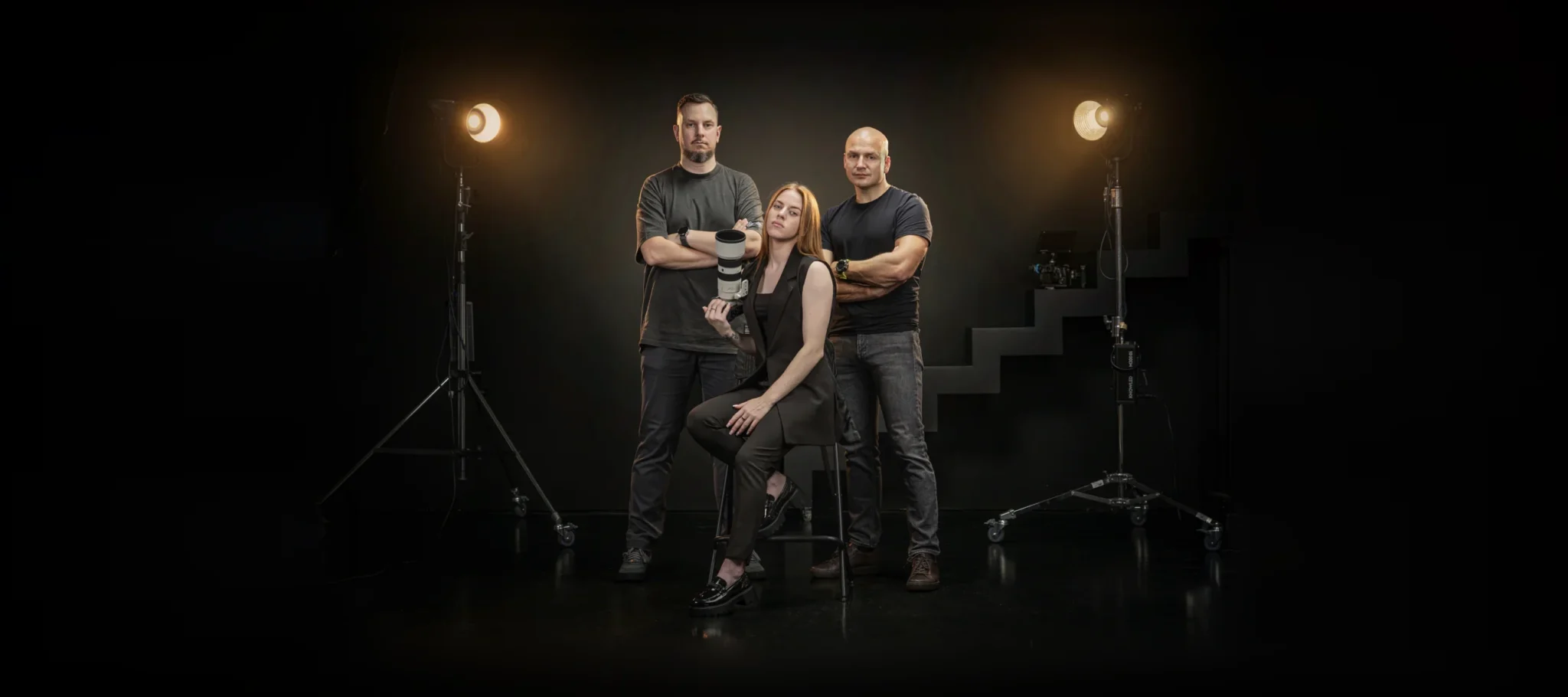 The Mačiukas Media crew — Eugenijus Mačiukas, Gabija Barštytė and Vilius Žukauskas — in a studio with film lights